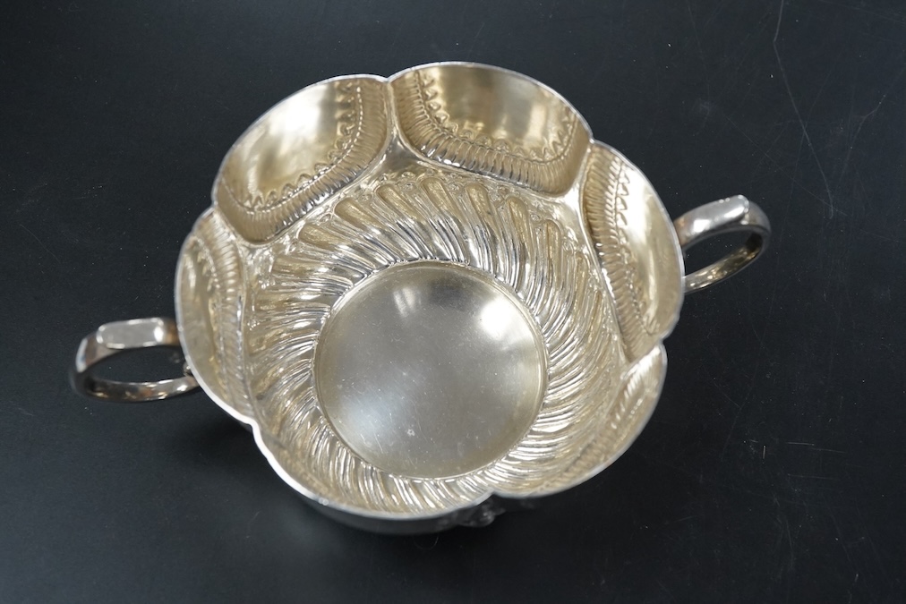 A late Victorian silver twin handled porringer in ealry 18th century style hanlded to handle 17cm., weight approx. 6.48ozt
